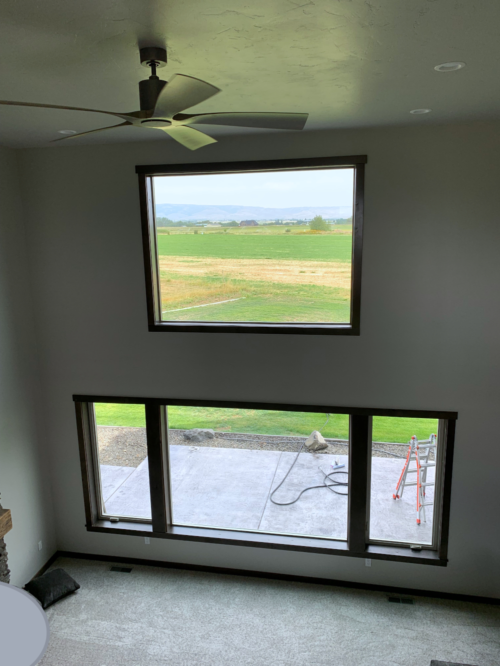 Gray house with large living room windows